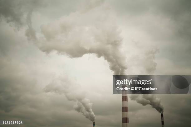 industrial chimneys smoking - air pollution stock pictures, royalty-free photos & images