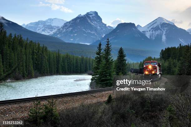 eastbound train and bow range, banff national park, alberta, canada - rocky mountains north america stock-fotos und bilder