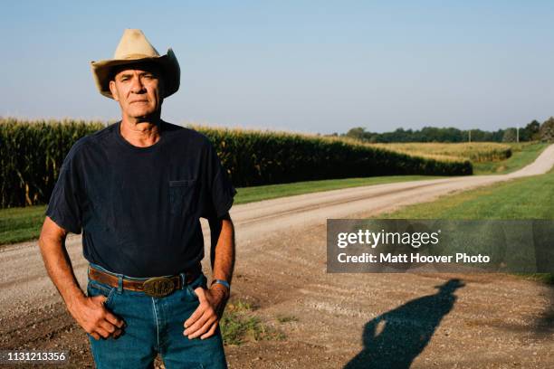 farmer standing on dirt road - farmer confident serious stock pictures, royalty-free photos & images