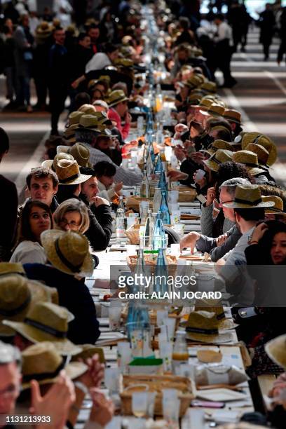 People take part in an attempt to break the Guinness World Records of the longest table to celebrate the international food market of Rungis' 50th...
