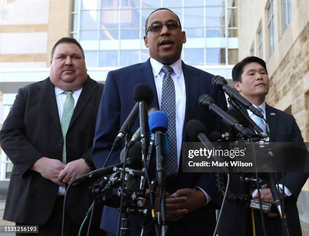 Special Agent Gordon Johnson , speaks while flanked by U.S. Attorney Robert Hur speaks while flanked by Art Walker of the Coast Guard Investigative...