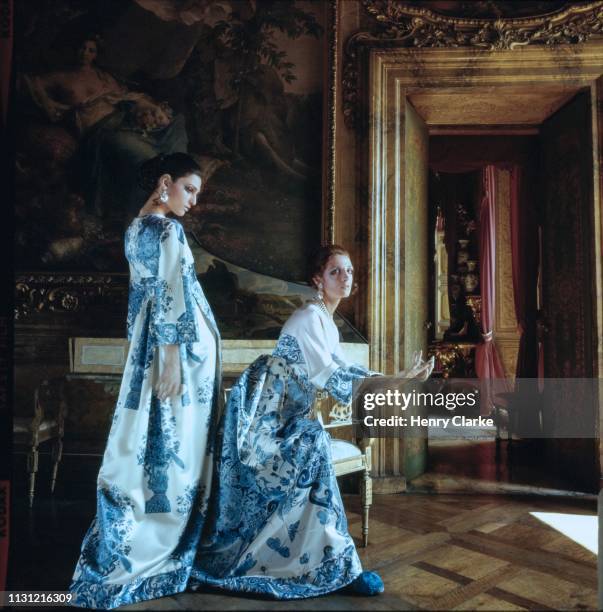 Two models in the Palazzo Borghese apartment of Agnes Bruguier wearing Valentino gowns made of Delft blue and white print Taroni silk with slippers...