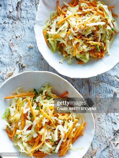 still life with bowls of mauritian pickled coleslaw (zasar) - coleslaw stock pictures, royalty-free photos & images