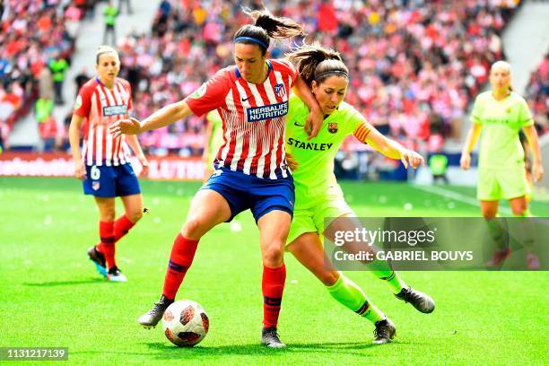 Atletico Madrid's midfielder Silvia Meseguer vies with Barcelona FC's midfielder Vicky Losada during the Spanish league football match between Club...