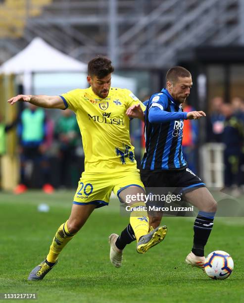 Alejandro Dario Gomez of Atalanta BC competes for the ball with Filip Djordjevic of Chievo during the Serie A match between Atalanta BC and Chievo at...