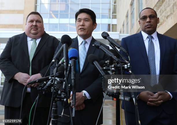 Attorney Robert Hur speaks while flanked by FBI Special Agent Gordon Johnson , and Art Walker of the Coast Guard Investigative Service, after a...