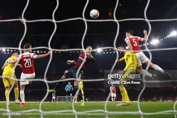 Sokratis Papastathopoulos of Arsenal scores his team's third goal during the UEFA Europa League Round of 32 Second Leg match between Arsenal and BATE...