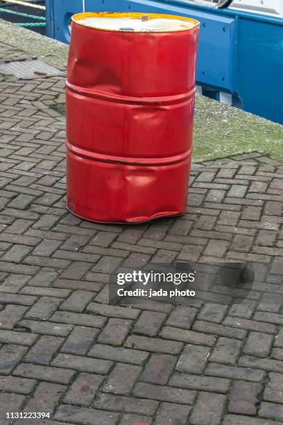 dented red oil barrel - oil drum stock pictures, royalty-free photos & images