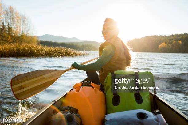 a woman on a canoe adventure - canoe ストックフォトと画像
