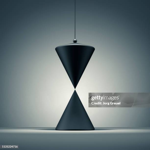 cone hanging above another cone - schietlood-meetinstrument stockfoto's en -beelden
