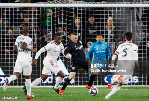 United forward Wayne Rooney controls the ball between Real Salt Lake defender Nedum Onuoha and midfielder Kyle Beckerman during a MLS match between...