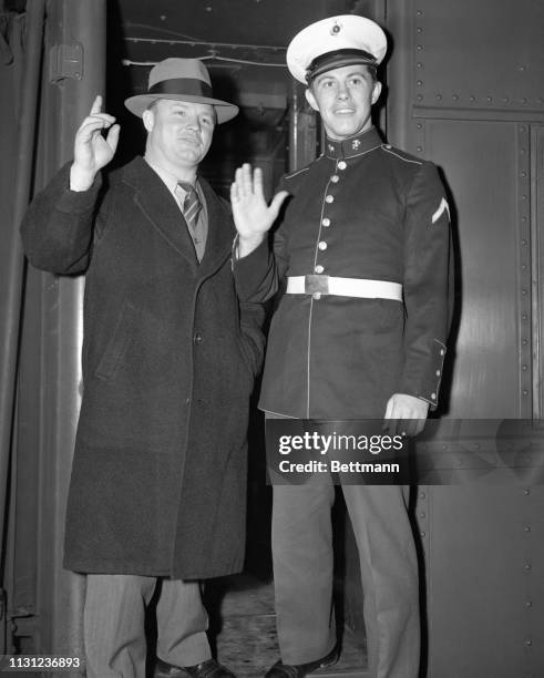 Wearing his U.S. Marine uniform for the first time, Frankie Sinkwich, of the University of Georgia arrives in Pennsylvania station with Wally Butts,...