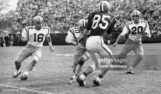 S famed All-American Billy Cannon gets an assist by way of a block thrown by fullback J.W. Brodnax on Clemson's Sam Anderson and picks up 7 yards...