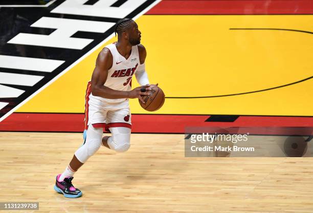 Dwyane Wade of the Miami Heat brings the ball up the court in the first half against the Charlotte Hornets at American Airlines Arena on March 17,...
