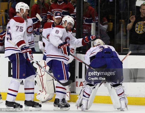 Jaroslav Spacek of the Montreal Canadiens tries to console teammate Carey Price after Price gave up the game winner in overtime to Nathan Horton of...