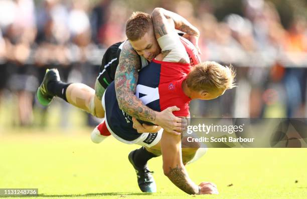 James Harmes of the Demons is tackled by Dayne Beams of the Magpies during the AFL Practice Match between Collingwood and Melbourne at Olympic Park...