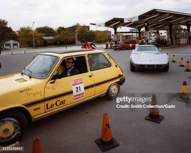 Renault 5 and a Chevrolet Corvette approach a parking lot checkpoint during a fuel efficiency driving event, 1975. Image courtesy US Department of...