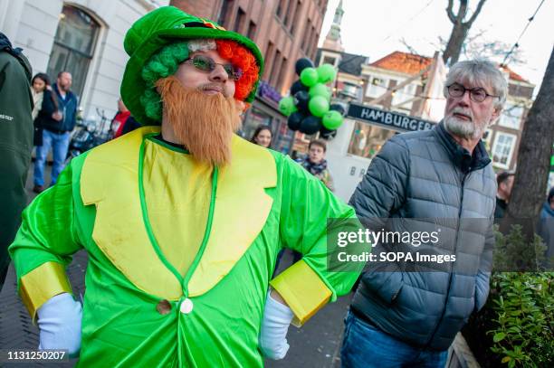 Man is seen wearing a leprechaun costume during the celebration. St. Patrick's day was celebrated for the ninth time in the Dutch city of The Hague....