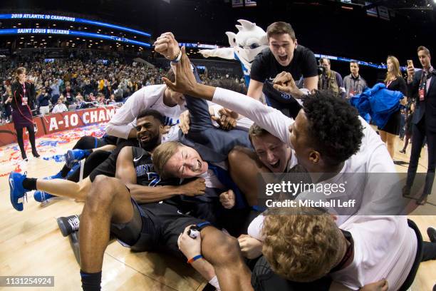 Tramaine Isabell Jr. #2 and head coach Travis Ford of the Saint Louis Billikens celebrate with the rest of the team after the championship game of...