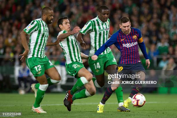 Barcelona's Argentinian forward Lionel Messi shoots to score a goal during the Spanish league football match between Real Betis and FC Barcelona at...