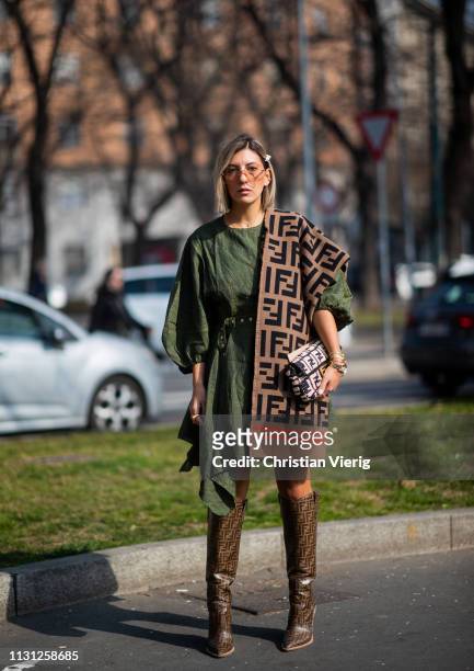Ylin Koenig is seen wearing scarf, bag, boots, green dress outside Fendi on Day 2 Milan Fashion Week Autumn/Winter 2019/20 on February 21, 2019 in...