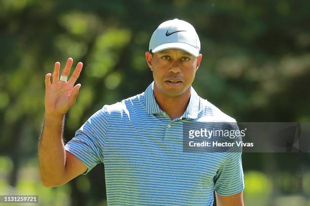 Tiger Woods of the United States acknowledges the crowd on the fifth green during the first round of World Golf Championships-Mexico Championship at...