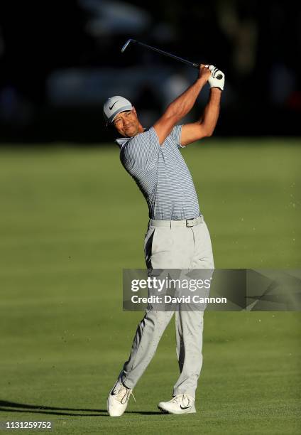 Tiger Woods of the United States plays his second shot on the 18th hole during the first round of World Golf Championships-Mexico Championship at...