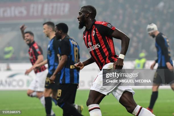 Milan's French midfielder Tiemoue Bakayoko reacts after scoring during the Italian Serie A football match AC Milan vs Inter Milan at the San Siro...