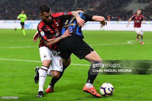 Milan's Spanish forward Suso and Inter Milan's Slovak defender Milan Skriniar go for the ball during the Italian Serie A football match AC Milan vs...