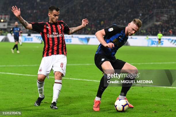 Inter Milan's Slovak defender Milan Skriniar holds off AC Milan's Spanish forward Suso during the Italian Serie A football match AC Milan vs Inter...