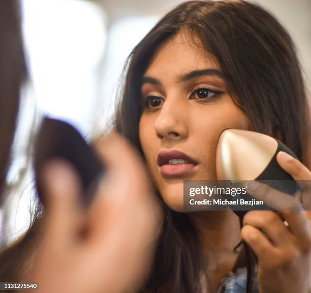 Jennalyn Ponraj using QYKsonic skincare device at at Giveback Day at TAP - The Artists Project on February 21, 2019 in Los Angeles, California.