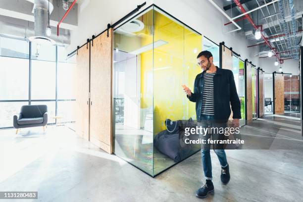 entrepreneur in co-working office - coworking spaces stock pictures, royalty-free photos & images