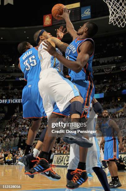 Kenyon Martin of the Denver Nuggets is fouled by Kevin Durant of the Oklahoma City Thunder as Serge Ibaka of the Oklahoma City Thunder helps with...