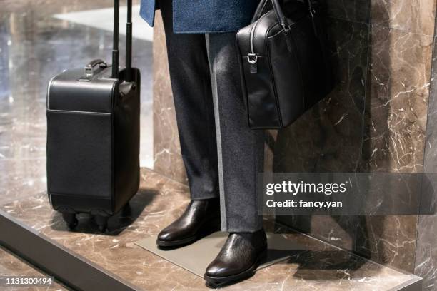 close up of model in a window display - suitcase close stock-fotos und bilder