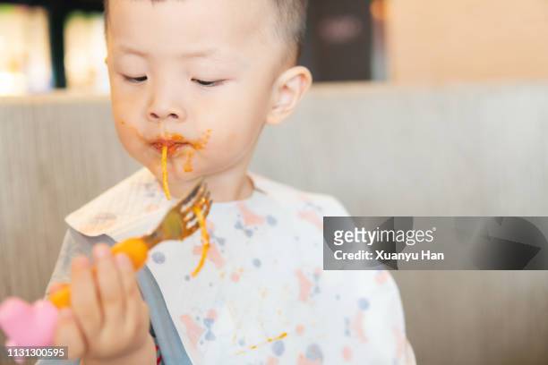 little boy eating spaghetti - who could play young han solo stock pictures, royalty-free photos & images