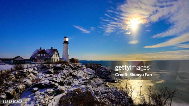 snow moon rise on portland head lighthouse after snow 2019 - maine winter stock pictures, royalty-free photos & images