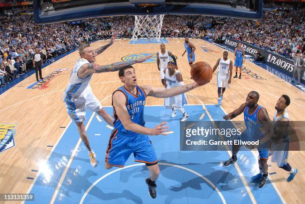 Nick Collison of the Oklahoma City Thunder shoots against Chris Andersen of the Denver Nuggets in Game Three of the Western Conference Quarterfinals...