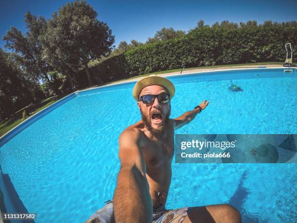 man falling in swimming pool: summer mood - cannon ball pool stock pictures, royalty-free photos & images