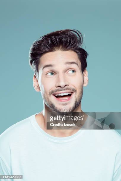 excited young man looking away - mouth talking stock pictures, royalty-free photos & images
