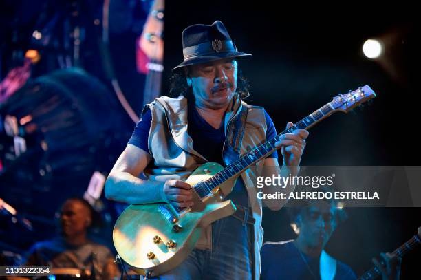 Mexican born guitar player Carlos Santana performs during the second day of the "Vive Latino" music festival in Mexico City on March 17, 2019.