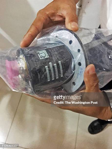 An Indonesian aviation official holds an angle-of-attack sensor shortly after it was recovered from the Lion Air crash last October that killed 189...