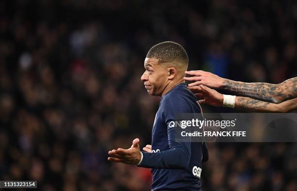 Paris Saint-Germain's French forward Kylian Mbappe celebrates after scoring a goal during the French L1 football match Paris Saint-Germain vs...