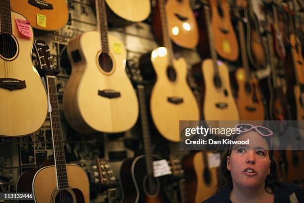 Customer looks at guitars in a store on Denmark Street on April 20, 2011 in London, England. Denmark Street, in the Soho area of central London,...