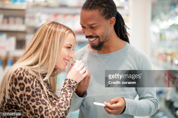 couple smelling perfume - choosing perfume stock pictures, royalty-free photos & images