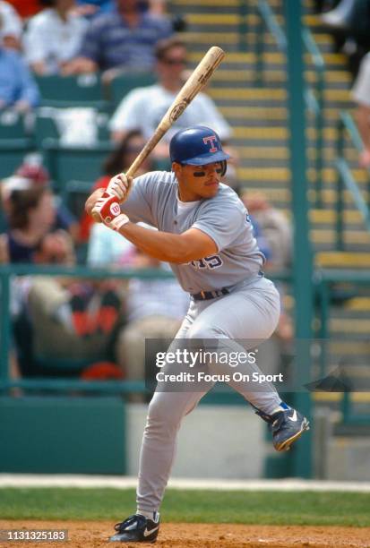 Catcher Ivan Rodriguez of the Texas Rangers bats during a Major League Baseball game circa 1991. Rodriguez played for the Rangers from 1991-2002 and...