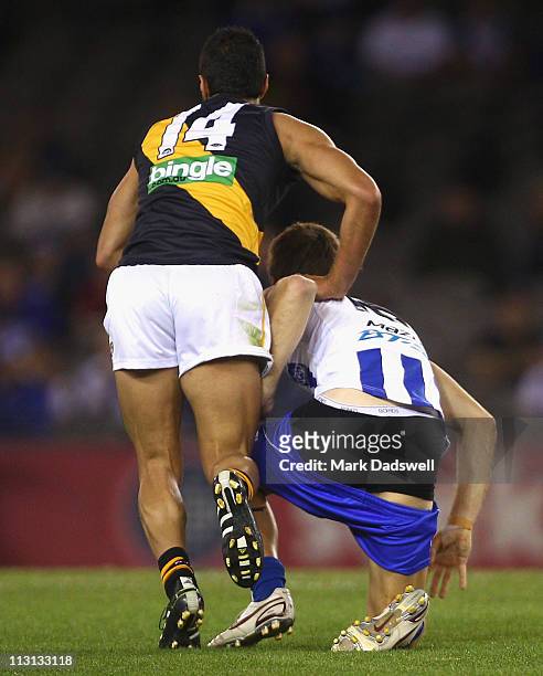 Shaun Atley of the Kangaroos gets back on his feet and pulls his shorts up during the round five AFL match between the North Melbourne Kangaroos and...