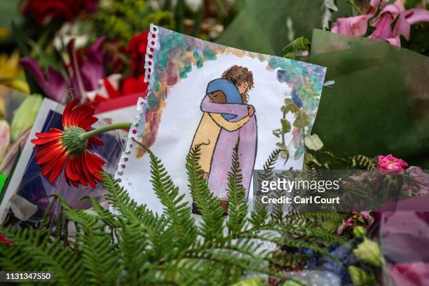 Picture is left among flowers and tributes near Al Noor mosque on March 18, 2019 in Christchurch, New Zealand. 50 people were killed, and dozens are...