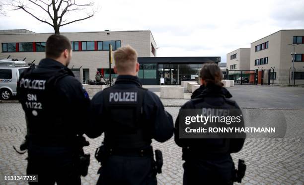 Policemen stand on March 18, 2019 in front of the Higher Regional Court in Dresden, eastern Germany, where a trial starts against a Syrian man...