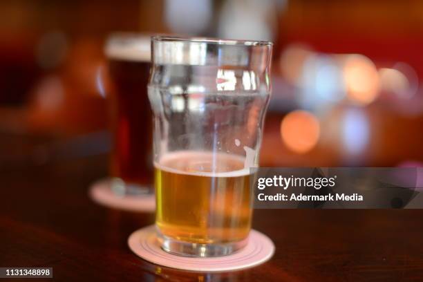 two pints in the pub - half full stock pictures, royalty-free photos & images