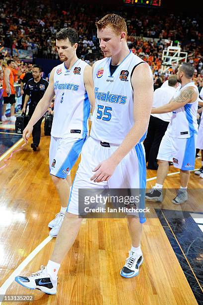 Gary Wilkinson and Kirk Penney of th Breakers walk off the court after losing game two of the NBL Grand Final series between the Cairns Taipans and...